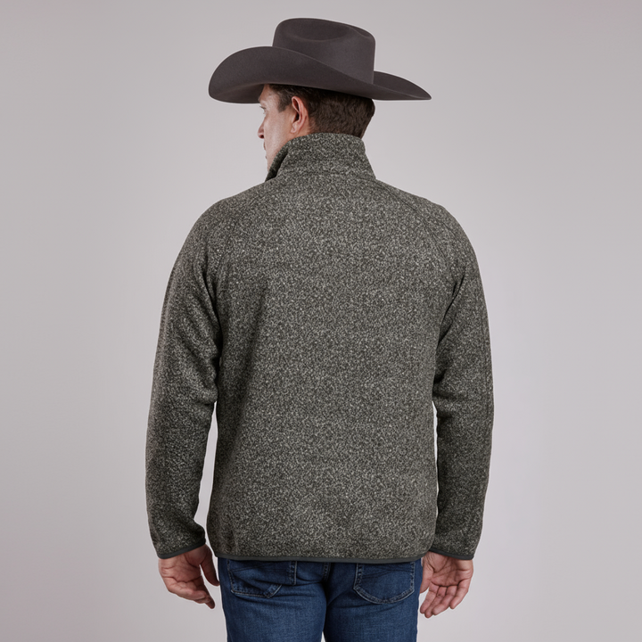 Person wearing a gray fleece jacket and cowboy hat on a light gray background