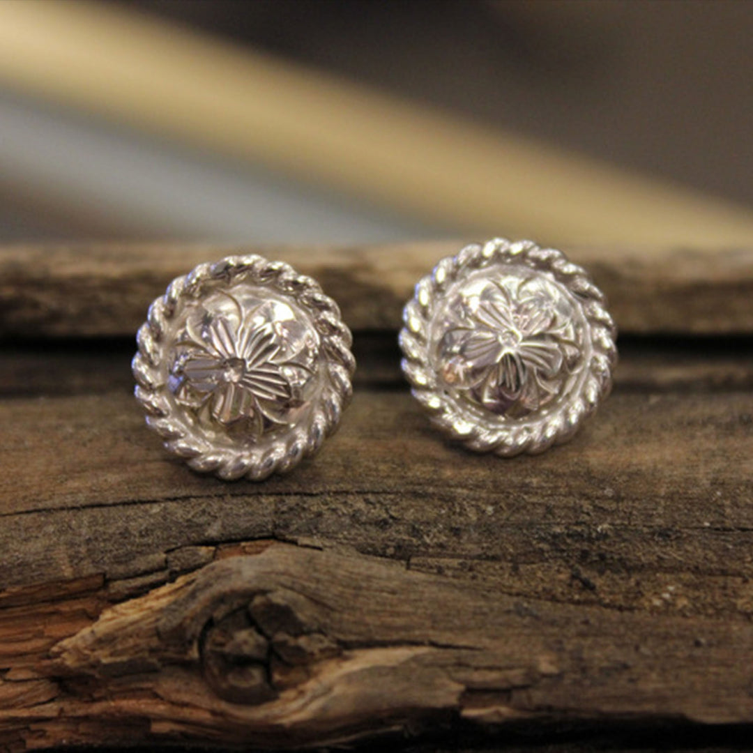 Hand-engraved sterling silver post back earrings with rope edge.